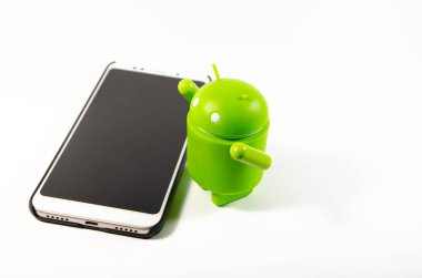 Mayıs 2019. Los Angeles, Amerika Birleşik Devletleri. Beyaz bir arka plan ve bir akıllı telefon ile Yeşil plastik Android rakam. Şekil, logo Android, Google