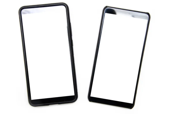 Två Smartphones Svart Färg Med Vit Skärm Ligger Vit Bakgrund — Stockfoto