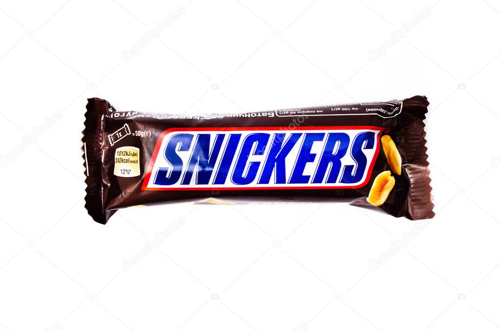 June 2020. Kiev, Ukraine. One small single snickers bar on a white background. Snickers with nuts in macro. Snickers Banner