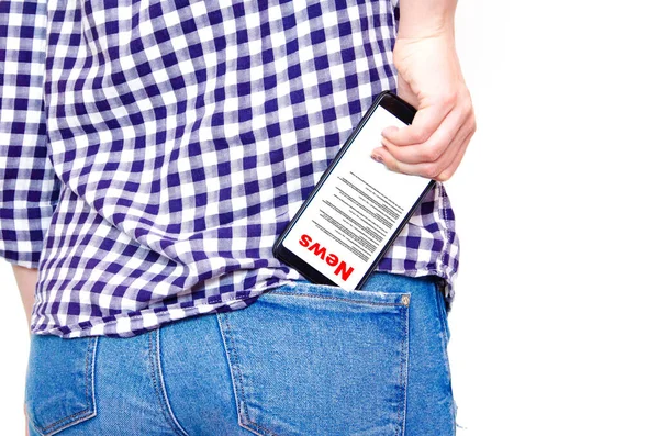News. Reading the news. The inscription red news on the smartphone screen. A girl in a plaid shirt pulls out, hides a smartphone in the back pocket of jeans