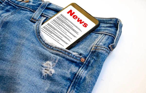 News. Reading the news. The inscription red news on the smartphone screen lies in a jeans pocket. A smartphone with a red inscription news sticks out of a jeans pocket on a white background