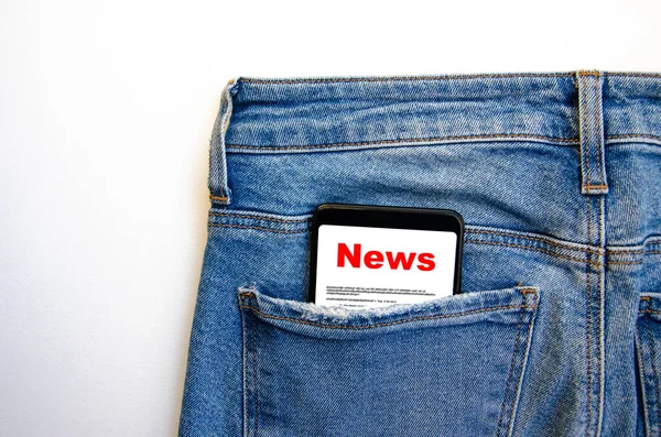 News. Reading the news. The inscription red news on the smartphone screen lies in a jeans pocket. A smartphone with a red inscription news sticks out of a jeans pocket on a white background