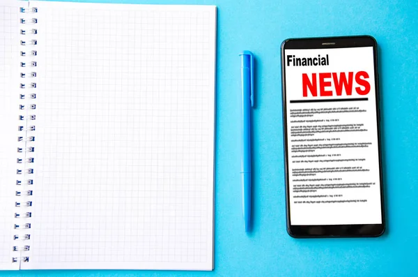 Smartphone Screen Inscription Financial News Lies Next Notebook Pen — Stock Photo, Image