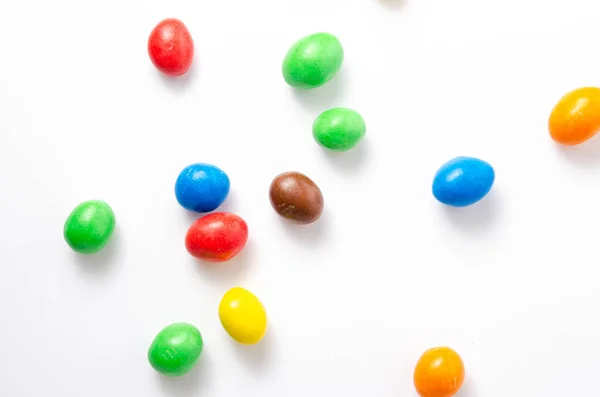 M & M\'s in packaging on a white background. Glazed nuts spilled out of the packaging on a white background cc close-up. M & M\'s on a white background balls top and bottom view. M & M\'s cutaway. July 2020. Kiev, Ukraine