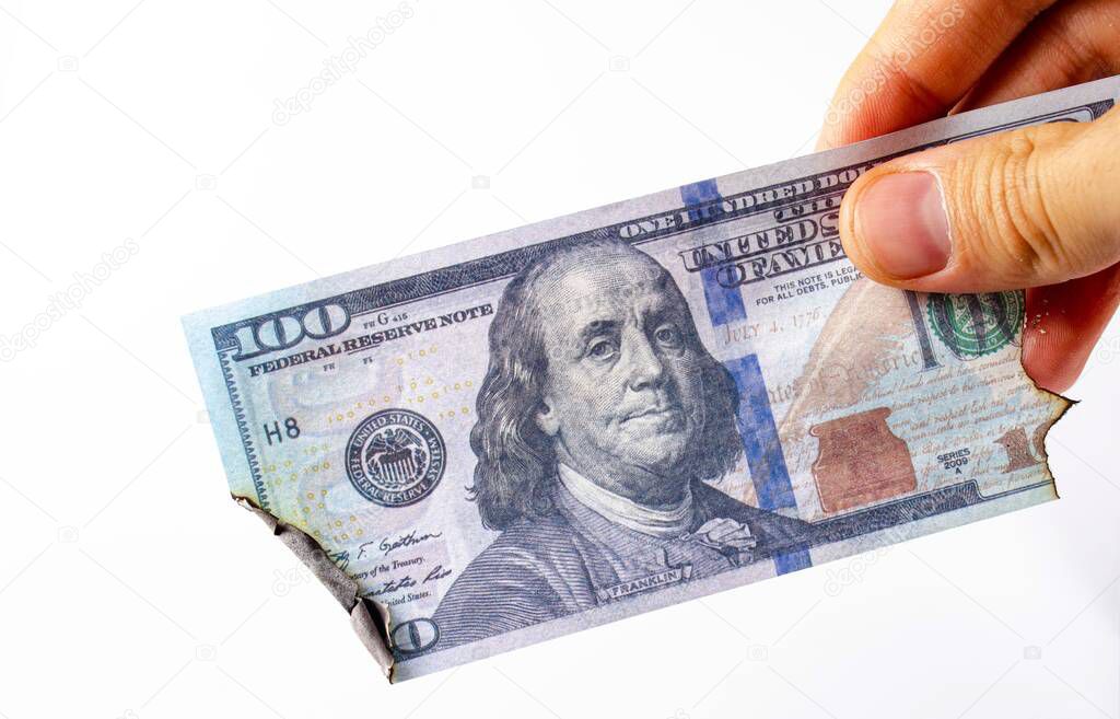 American dollars in a man's hand on a white background first-person view. Burnt dollars. Dollars are burning, Ashes, fire