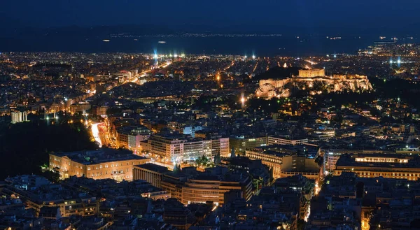 Atina ve Akropolis 'i Parthenon, Yunan Parlamentosu ve Zeus tapınağının kalıntılarıyla gece görüşü. UNESCO dünya mirası sahasının ünlü ikonik görüntüsü.
