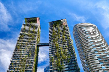 26 Kasım 2019 - Kuala Lumpur, Malezya: Le Nouvel KLCC 'nin yemyeşil dikey bahçeleri ve Jean Nouvel ve K Konutları' nın yüksek katlı lüks binaları DCM Mimarlar tarafından yapılmıştır. Şehir yeşili, sürdürülebilir tasarım, bulutlu açık mavi gökyüzü