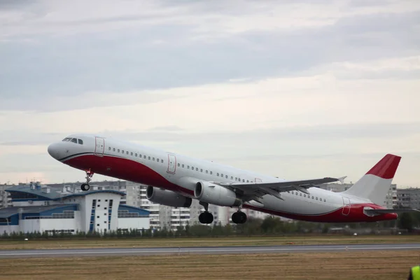 Passenger plane takes off from the airport runway. Side-view of aircraft. Horizontal image