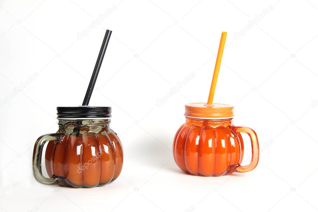 two glasses of pumpkin juice isolated on white background. Image contains copy space