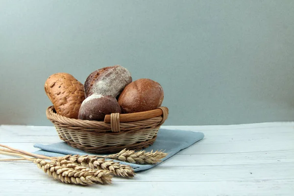 Frisches Brot Weidenkorb Und Ähren Auf Blauer Serviette Auf Holztisch — Stockfoto