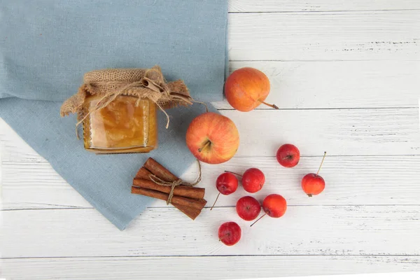 Glass Pot Jam Apples Cinnamon Blue Napkin White Wooden Background — Stock Photo, Image