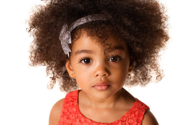 Close up portrait of african-american little girl in studio, isolated on white background