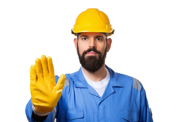 Middle age bearded workman with yellow helmet and uniform making stop gesture with his hand denying a situation that could wrong. Isolated over white background — Stock Photo, Image