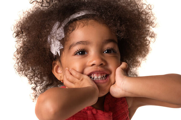 childhood and people concept- cute african american girl touches her cheeks, isolated