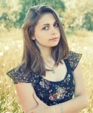 Doğal arka plan yönünde benzeyen bir kız portresi.