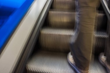 Erkekler ayakları üzerinde yürüyen merdiven, arka plan bulanık