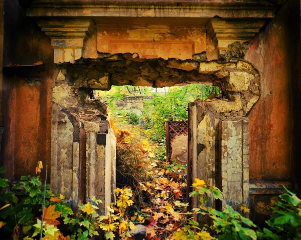 ruined wall of an old house and the window opening, autumn day