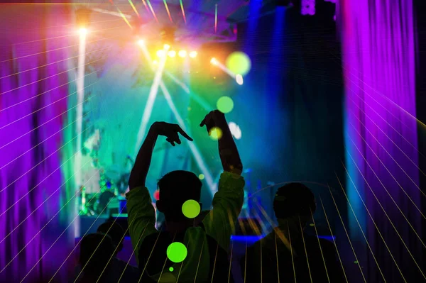 stock image silhouettes of concert crowd in front of bright stage lights