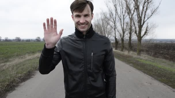 Metraje Del Hombre Sonriente Saludando Cámara Mientras Está Parado Carretera — Vídeo de stock