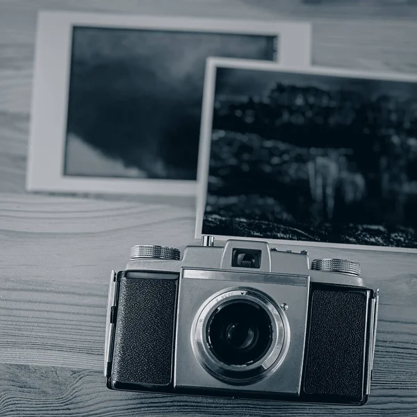 Vintage analog camera and old photographic prints. Web banner. Business concept.