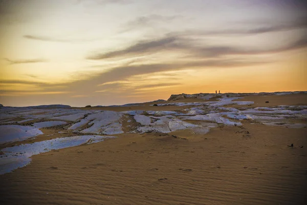 Desert landscape in Egypt. White desert in Egypt (Farafra). White stones and yellow sands. Sahara desert at sunset.