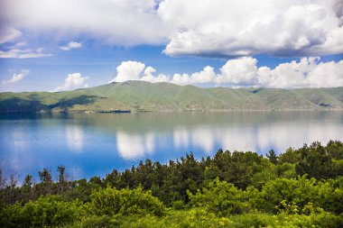 Beautiful view of Sevan lake with turquoise water and green hills, Sevan, Armenia  clipart