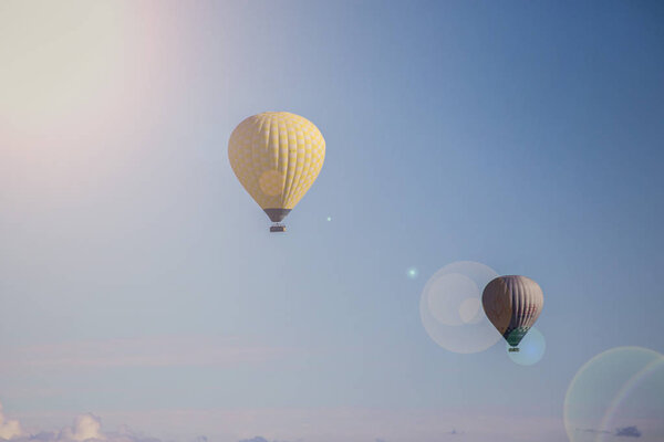 Hot Air Balloons in blue sky with sunbeams effect, Cappadocia, Turkey
