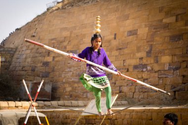 JAISALMER, INDIA - Aralık 2017: Jaisalmer, Rajasthan, Hindistan 'daki geleneksel fuarda Hintli kız halat cambazı (mela)