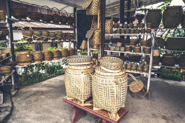 Wicker products from palm leaves, traditional Laos souvenirs, different size bowls and baskets made from palm leaves on the market in Laos
