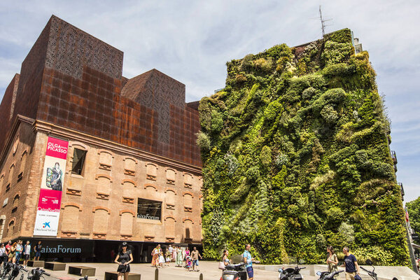 MADRID, SPAIN - June 2019: Green wall Madrid. Madrid's epic vertical garden on the front of the CaixaForum is one of the world's most lush living walls, Spain