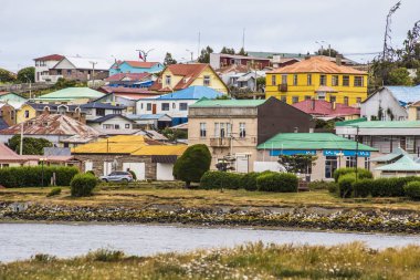 PORVENIR, CHILE - January 2019: Colorful houses at Porvenir town, capital of both the synonymous commune and the Chilean Province of Tierra del Fuego of Magallanes y la Antrtica Chilena Region, Chile clipart