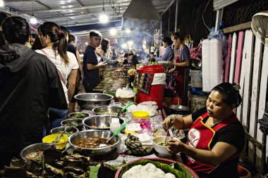 Luang Prabang, Laos - Nisan 2019: Luang Prabang, Laos 'ta gıda tezgahı. Yerel halk Laos gece pazarında yiyecek satıyor.