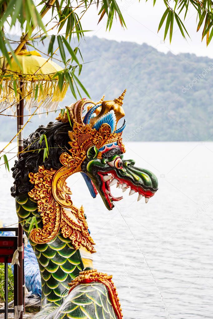 Traditional dragon head against the lake at Beratan Temple in Bali, Indonesia