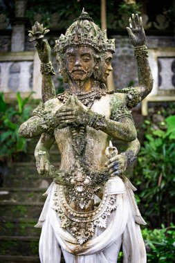 Magnificent weathered asian statue in green garden