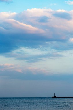 Chornomorsk, Ukrayna - Haziran 2020: Chornomorsk, Ukrayna 'da bulutlu bir günde güzel çizgili deniz feneri