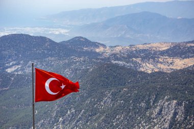 Flag of Turkey waving with mountains background