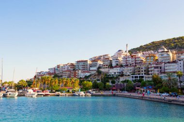 Rıhtımda demirli yatları olan şehir kıyısı.