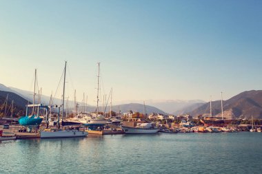 Luxurious yachts moored at pier at the evening