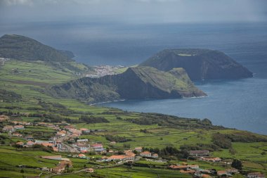 Portekiz 'in Azores adalarındaki Atlantik okyanus kıyısındaki uçurumlarda parlak evler