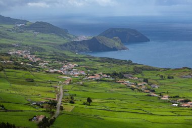 Portekiz 'in Azores adalarındaki Atlantik okyanus kıyısındaki uçurumlarda parlak evler