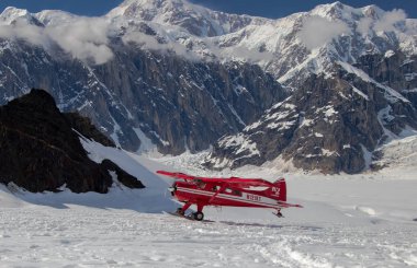 Flight seeing over denali walking on the glacier clipart