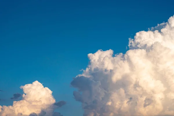 The blue sky with moving white clouds. The sky is a beautiful color shade suitable for use as a background image.