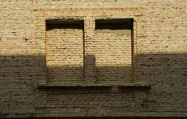 Brick facade without plaster with two brick-built windows. — Stock Photo, Image