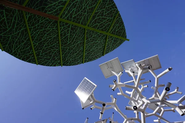 Smart charging solar panels tree and a man made giant green leaf.