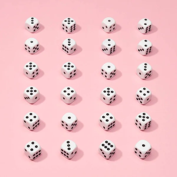 Square gaming dice pattern on pink background in flat lay style