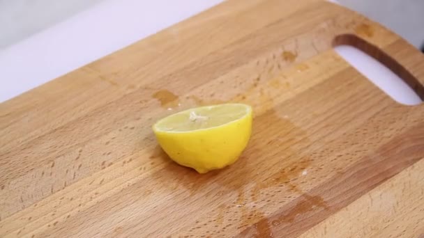 Knife a cutting juicy lemon on a white background. — Stock Video