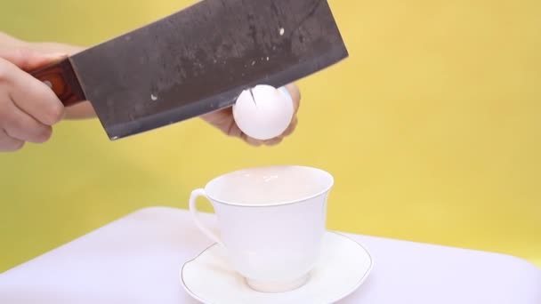 Яйцо в стакане на желтом фоне — стоковое видео