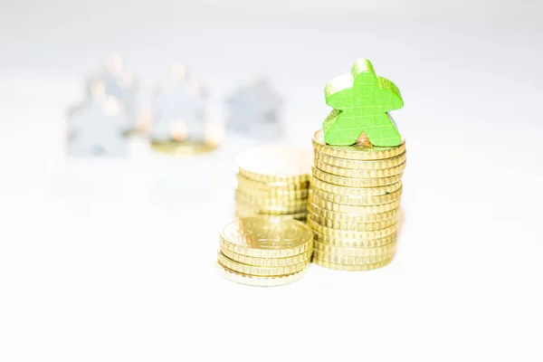 Unequal distribution of assets shown with wooden meeples on pile — Stock Photo, Image