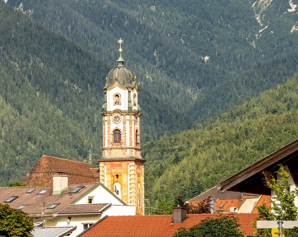 view on the tower of the catholic church saint peter and paul in mittenwald, bavaria, germany
