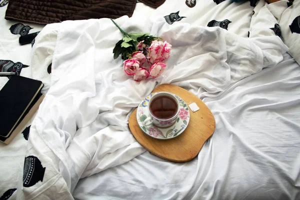 tea in the bed, ready for relaxation some peonies in the back